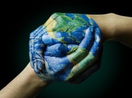 Hands painted with globe image and clasped together